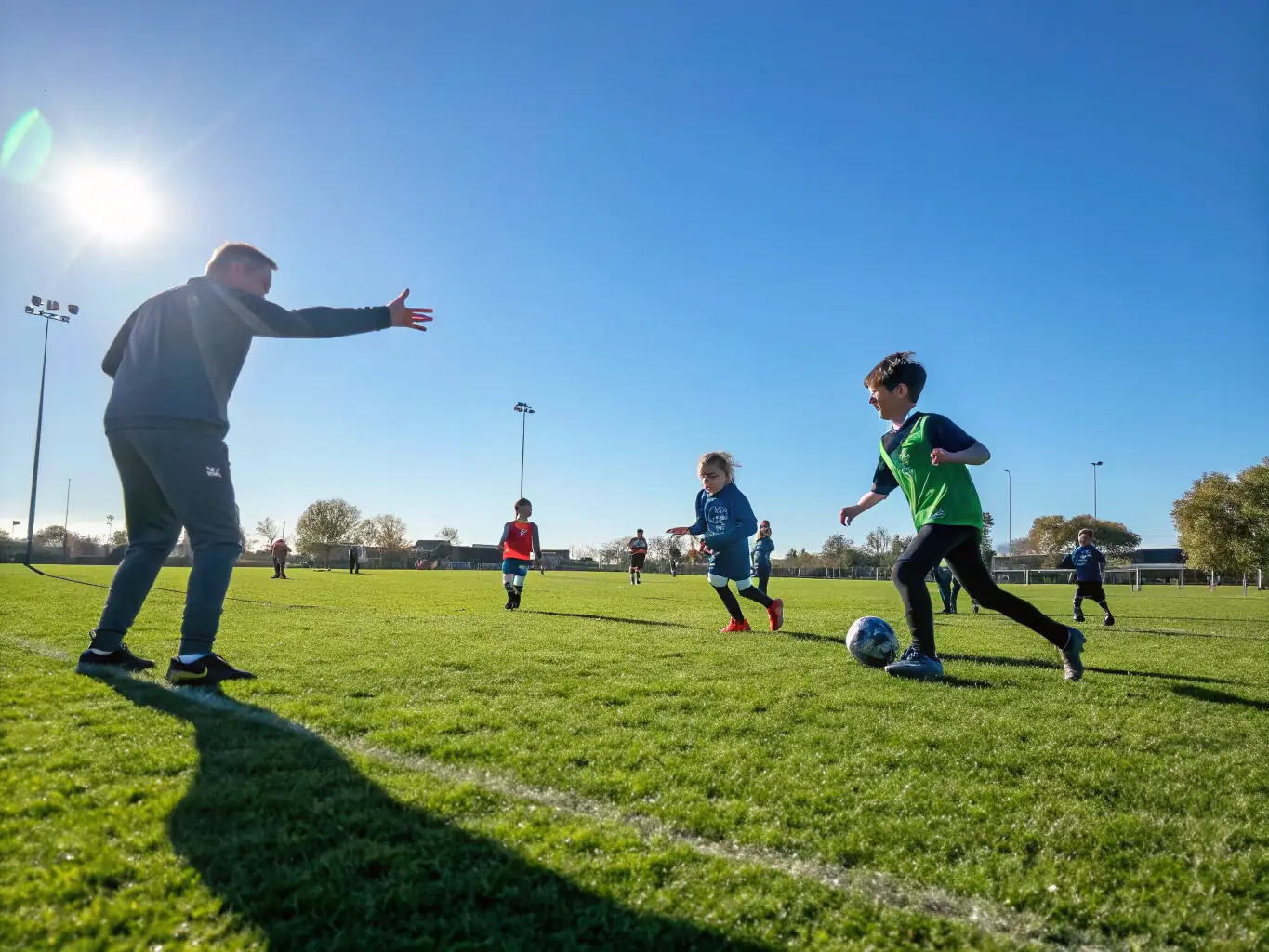 A vibrant image of children and adults playing soccer on a sunny field, showcasing active participation and community engagement in CELS's Community Sports Programs.